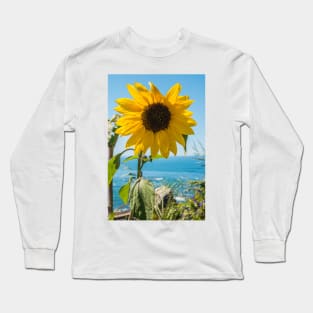 Sunflower field. Sunflower with blue sky and the sea in backgorund. Summer background, bright yellow sunflower over blue sky. Landscape with sunflower field over cloudy blue sky. Long Sleeve T-Shirt